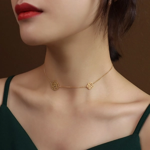 18K gold plated titanium necklace featuring double cutout rose charms on a delicate chain