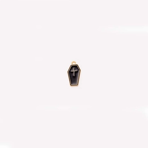 Detail of gothic black coffin charm with golden trim and cross for DIY jewelry making