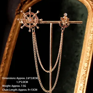 Gold nautical collar pin set with anchor, ship wheel, chains and white crystals
