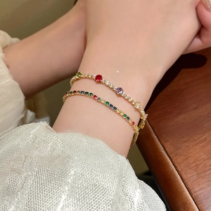 Close-up of gold-plated tennis bracelets with colorful round-cut zircon stones