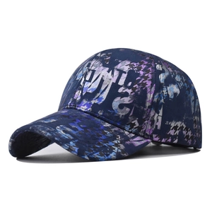 Tie-dye baseball cap featuring blue and purple graffiti letter patterns on a curved brim