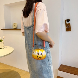 Fashionable gradient orange round crossbody bag with pumpkin pattern worn by a model