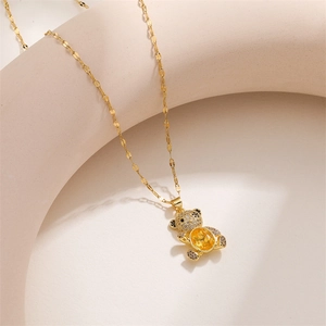 Detail of gold bear pendant with yellow zircon and micro-pave crystals on flat link chain