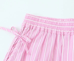 Detail of pink and white striped fabric showing elastic waistband and bow tie