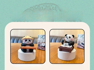 Detail of cute resin pandas playing guqin and writing calligraphy in Chinese style