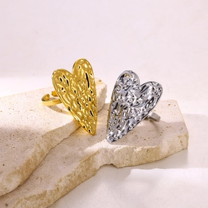 Detailed view of heart-shaped rings with embossed texture on stone surface