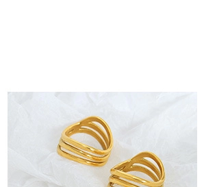 Macro detail of triple-layered wavy cutout rings in polished 18K gold plated steel