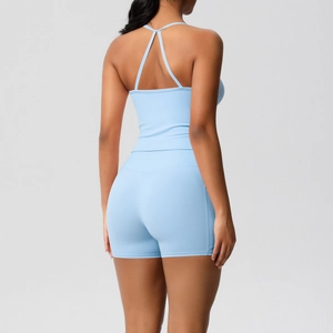 Rear view of light blue yoga set featuring a criss-cross strap top and high-waist shorts