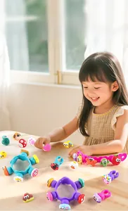 Girl playing with DIY silicone cartoon animal bracelet kit in cozy sunlight setting