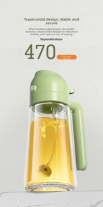 Detailed view of a 470ml glass oil dispenser with green lid and stable wide base