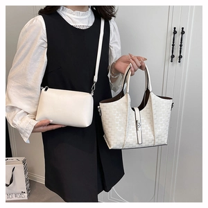 Detail of off-white monogram tote and crossbody bag set worn by a model