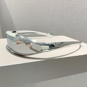 Close-up of futuristic silver wrap-around sunglasses with metallic finish and sleek lens