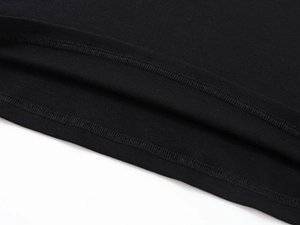 Detail view of the fine stitching and high-quality hem on a black Tencel wool T-shirt