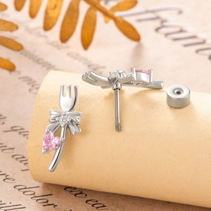 Silver bow fork stud earrings with pink heart zircon and secure screw back closure