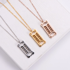 Square abacus pendant necklaces in silver, gold, and rose gold on a stone surface