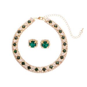 Luxury gold necklace and earrings set with emerald green stones and diamond accents