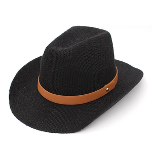Close-up of black woven cowboy hat with a brown faux leather belt and gold rivet detail