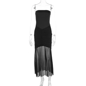 Detail of strapless black dress featuring ruching and sheer mesh fish tail hemline