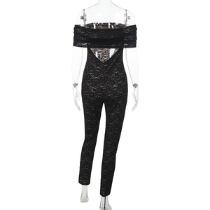 Detailed back view of black lace jumpsuit showing V-shaped open back and sheer floral mesh