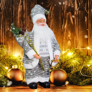 Detailed view of plush Santa doll with silver gift bag and gold horn on festive pine wood