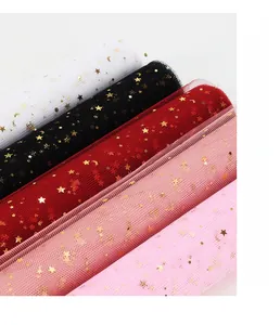 Detail of star and moon bronzing mesh fabric rolls for flower wrapping in multiple colors