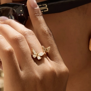 Elegant gold butterfly ring with zircon wings worn by model in light luxury style