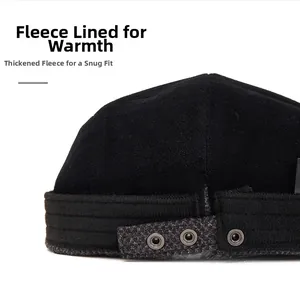 Detail view of black newsboy hat with warm fleece lining and metal eyelet decoration