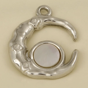 Macro shot of silver stainless steel moon pendant with circular white shell inlay