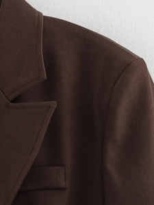 Detail of deep brown blazer collar and shoulder made from fine woven fabric