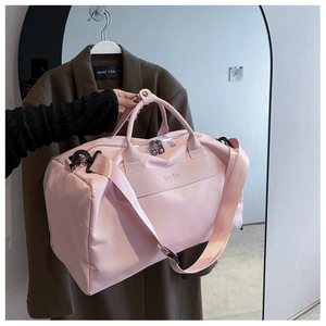 Detail of pink nylon fitness bag with NIFTY BAG logo and adjustable shoulder strap