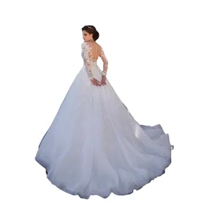 Elegant long sleeve lace wedding dress with a long train and buttoned illusion back
