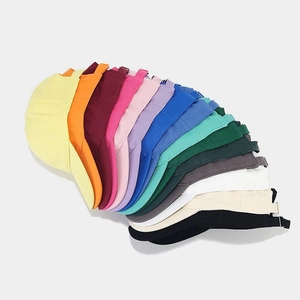 Classic cotton baseball caps shown in twelve vibrant solid colors with curved brims
