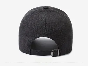Detail view of dark grey knitted baseball cap featuring an adjustable metal buckle