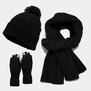 Detail of cable knit texture on winter beanie scarf and touchscreen glove set