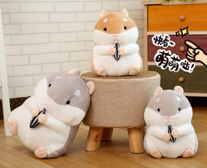 Three plush hamster dolls holding sunflower seeds in brown and grey soft textures