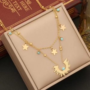 Double-layered gold stainless steel necklace featuring star charms and turquoise sun pendant