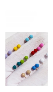 Macro view of colorful enamel ball stud earrings in various bright candy colors