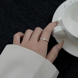 S925 sterling silver butterfly ring with twisted zircon band worn on model hand