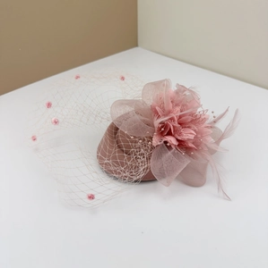 Elegant pink vintage fascinator hat with feathers, flowers and polka dot mesh veil