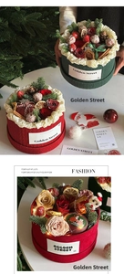 Detail of Christmas flower box with roses, strawberries and festive LED string lights