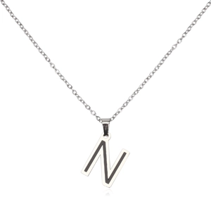 Macro detail of silver stainless steel letter N pendant with black inlay on O-chain