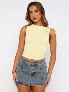 Detail of light yellow sleeveless crop top with asymmetric neck and drawstring shoulder