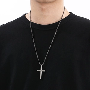 Minimalist silver stainless steel cross pendant necklace for men worn on black t-shirt