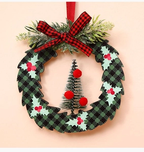 Detailed view of a round Christmas wreath with cedar tree and red-black plaid bow tie