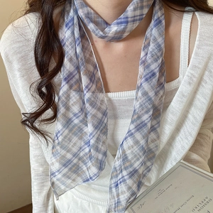 Detailed close-up of a pastoral blue plaid mesh scarf necklace worn by a female model