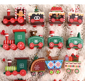 Detailed view of hand-painted wooden Christmas trains on a soft white plush background