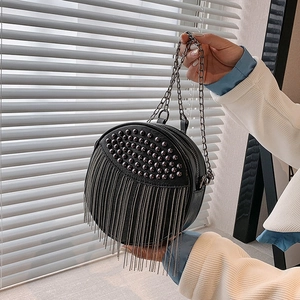 Stylish black leather round shoulder bag with metallic rivets and long fringe tassels