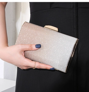 Detail of champagne gold gradient glitter surface on luxury evening clutch with metal clasp