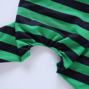 Detailed view of green and black striped dog pajama showing knit texture and seam stitching