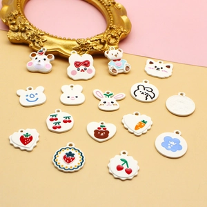 Assorted DIY jewelry charms featuring cute animals, strawberries and flower patterns